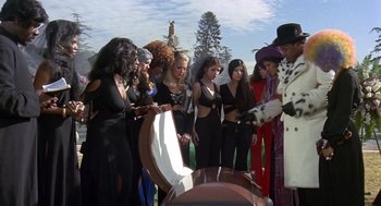 Movie still from “Truck Turner” (1974), directed by Jonathan Kaplan – A group of people standing next to each other in front of a coffin; Wide shot, High angle
