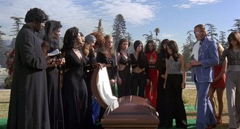 Movie still from “Truck Turner” (1974), directed by Jonathan Kaplan – A group of people standing around a coffin; Wide shot, High angle