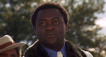 Movie still from “Truck Turner” (1974), directed by Jonathan Kaplan – A person wearing a jacket and a tie; Close Up shot, Low angle