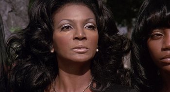 Movie still from “Truck Turner” (1974), directed by Jonathan Kaplan – A person with long black hair; Close Up shot, Low angle