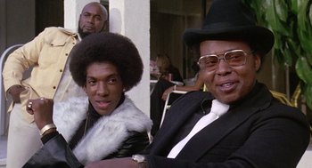 Movie still from “Truck Turner” (1974), directed by Jonathan Kaplan – A man and a woman sitting next to each other; Close Up shot, Low angle