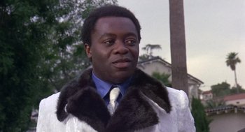 Movie still from “Truck Turner” (1974), directed by Jonathan Kaplan – A man in a white jacket and a blue tie; Close Up shot, Low angle