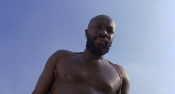 Movie still from “Truck Turner” (1974), directed by Jonathan Kaplan – A man with a beard is posing for a picture; Close Up shot, Low angle