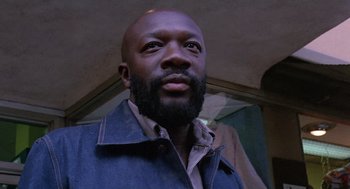 Movie still from “Truck Turner” (1974), directed by Jonathan Kaplan – A person with a beard looking at the camera; Close Up shot, Low angle