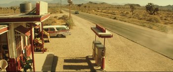 Movie still from “Truth or Dare” (2018), directed by Jeff Wadlow – An abandoned gas station on the side of the road; Extreme Wide shot, High angle