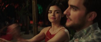 Movie still from “Truth or Dare” (2018), directed by Jeff Wadlow – A beautiful young lady sitting next to a man in a red dress; Close Up shot, Over the shoulder angle