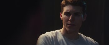 Movie still from “Truth or Dare” (2018), directed by Jeff Wadlow – A person wearing a white t - shirt; Close Up shot, Over the shoulder angle