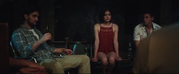 Movie still from “Truth or Dare” (2018), directed by Jeff Wadlow – A woman sitting on a chair in front of a man; Medium shot, High angle
