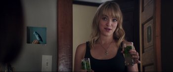 Movie still from “Truth or Dare” (2018), directed by Jeff Wadlow – A beautiful blonde woman holding a drink in her hand; Close Up shot, Over the shoulder angle