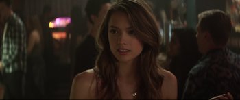 Movie still from “Truth or Dare” (2018), directed by Jeff Wadlow – A beautiful young woman with long brown hair; Close Up shot, Over the shoulder angle