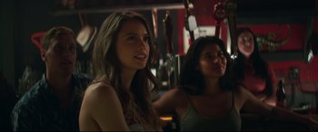 Movie still from “Truth or Dare” (2018), directed by Jeff Wadlow – Two young women sitting at a bar smiling for the camera; Close Up shot, Over the shoulder angle