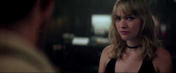 Movie still from “Truth or Dare” (2018), directed by Jeff Wadlow – A beautiful young blonde woman in a black dress; Close Up shot, Over the shoulder angle