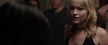 Movie still from “Truth or Dare” (2018), directed by Jeff Wadlow – A woman standing next to two other people; Close Up shot, Over the shoulder angle