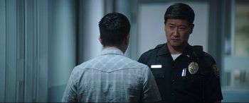 Movie still from “Truth or Dare” (2018), directed by Jeff Wadlow – Two men are standing in front of a mirror; Medium shot, Over the shoulder angle
