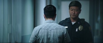 Movie still from “Truth or Dare” (2018), directed by Jeff Wadlow – Two men are standing in front of a mirror; Medium shot, Over the shoulder angle
