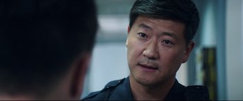 Movie still from “Truth or Dare” (2018), directed by Jeff Wadlow – A man in a police uniform talking to another man; Close Up shot, Over the shoulder angle