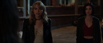 Movie still from “Truth or Dare” (2018), directed by Jeff Wadlow – A woman in a white shirt and a black jacket; Close Up shot, Over the shoulder angle