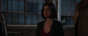 Movie still from “Truth or Dare” (2018), directed by Jeff Wadlow – A woman standing in a dark room looking at the camera; Close Up shot, Over the shoulder angle
