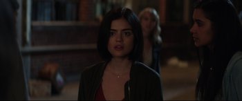 Movie still from “Truth or Dare” (2018), directed by Jeff Wadlow – A woman standing next to another woman in a dark room; Close Up shot, Over the shoulder angle