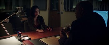Movie still from “Truth or Dare” (2018), directed by Jeff Wadlow – Two people sitting at a table in a room; Medium shot, Over the shoulder angle