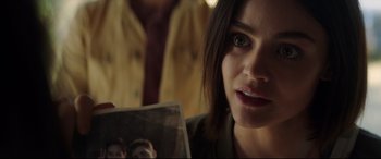 Movie still from “Truth or Dare” (2018), directed by Jeff Wadlow – A woman holding up a picture of a man; Close Up shot, Over the shoulder angle