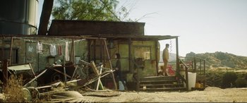 Movie still from “Truth or Dare” (2018), directed by Jeff Wadlow – Two people standing in front of an old building; Wide shot, Low angle
