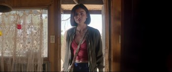 Movie still from “Truth or Dare” (2018), directed by Jeff Wadlow – A woman standing in front of an open door; Medium shot, Low angle
