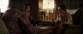 Movie still from “Truth or Dare” (2018), directed by Jeff Wadlow – A group of people sitting at a table in a room; Medium shot, Over the shoulder angle