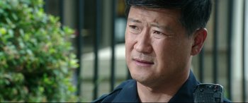 Movie still from “Truth or Dare” (2018), directed by Jeff Wadlow – A person wearing a police uniform; Close Up shot, Over the shoulder angle