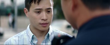 Movie still from “Truth or Dare” (2018), directed by Jeff Wadlow – A young man is talking to a police officer; Close Up shot, Over the shoulder angle
