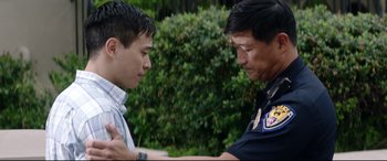 Movie still from “Truth or Dare” (2018), directed by Jeff Wadlow – A police officer and a young man talking to each other; Medium shot, Over the shoulder angle