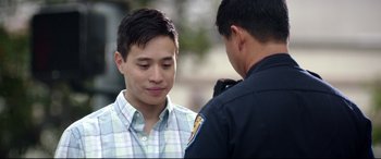 Movie still from “Truth or Dare” (2018), directed by Jeff Wadlow – A police officer talking to a man in a checkered shirt; Close Up shot, Over the shoulder angle