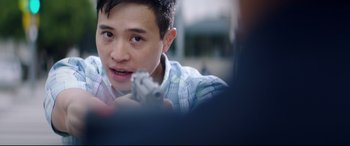 Movie still from “Truth or Dare” (2018), directed by Jeff Wadlow – A young man holding a cell phone in his hand; Close Up shot, Over the shoulder angle