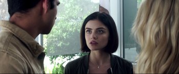 Movie still from “Truth or Dare” (2018), directed by Jeff Wadlow – A beautiful young lady looking at the camera; Close Up shot, Over the shoulder angle