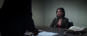 Movie still from “Truth or Dare” (2018), directed by Jeff Wadlow – A woman sitting in front of a man at a table; Medium shot, Over the shoulder angle