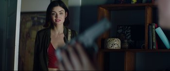 Movie still from “Truth or Dare” (2018), directed by Jeff Wadlow – A woman holding a knife in front of a mirror; Medium shot, Over the shoulder angle