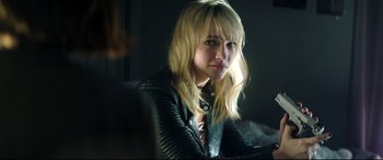 Movie still from “Truth or Dare” (2018), directed by Jeff Wadlow – A woman with blonde hair wearing a leather jacket; Close Up shot, Over the shoulder angle