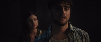 Movie still from “Truth or Dare” (2018), directed by Jeff Wadlow – A man and a woman standing next to each other in the dark; Close Up shot, Over the shoulder angle