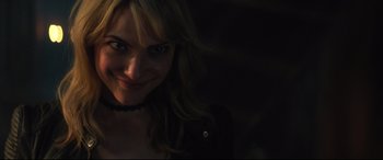 Movie still from “Truth or Dare” (2018), directed by Jeff Wadlow – A person smiling for the camera; Close Up shot, Over the shoulder angle