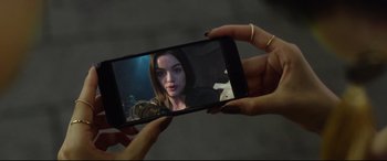 Movie still from “Truth or Dare” (2018), directed by Jeff Wadlow – A woman taking a picture of herself on a cell phone; Close Up shot, High angle