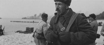 A black and white photo of a man in a military uniform