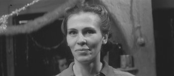 Movie still from “Twenty Days Without War” (1977), directed by Aleksey German – An old black and white photo of a woman; Close Up shot, Low angle