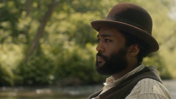 Movie still from “Anne with an E” (2017), created by Moira Walley-Beckett – A man with a beard wearing a brown hat; Close Up shot, Over the shoulder angle