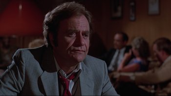 Movie still from “Twilight Zone: The Movie” (1983), directed by Steven Spielberg – An older man wearing a suit and a tie; Close Up shot, Over the shoulder angle
