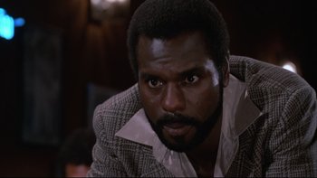 Movie still from “Twilight Zone: The Movie” (1983), directed by Steven Spielberg – A person wearing a suit and tie; Close Up shot, Low angle