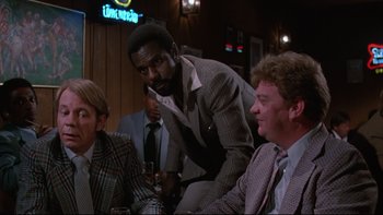 Movie still from “Twilight Zone: The Movie” (1983), directed by Steven Spielberg – A group of men sitting around a table; Medium shot, Over the shoulder angle