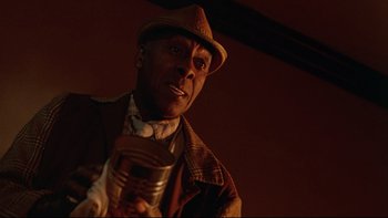 Movie still from “Twilight Zone: The Movie” (1983), directed by Steven Spielberg – A man in a hat holding a jar of food; Close Up shot, Low angle