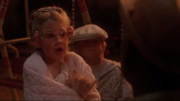 Movie still from “Twilight Zone: The Movie” (1983), directed by Steven Spielberg – A young girl is on a swing with an older man; Close Up shot, Over the shoulder angle