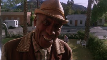 Movie still from “Twilight Zone: The Movie” (1983), directed by Steven Spielberg – An older man wearing a straw hat and a plaid jacket; Close Up shot, Low angle