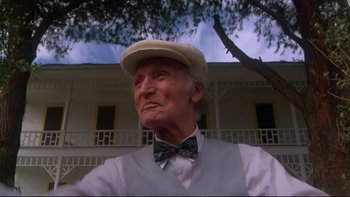 Movie still from “Twilight Zone: The Movie” (1983), directed by Steven Spielberg – An older man wearing a bow tie and a hat; Close Up shot, Low angle